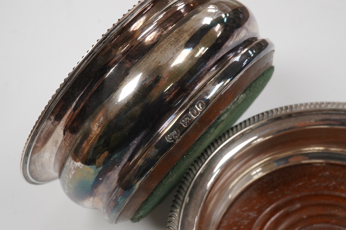 A pair of Elizabeth II silver mounted wine coasters, by C.J. Vander Ltd, London, 1961, overall diameter 15cm.